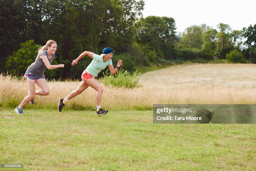 Two mature women racing in park