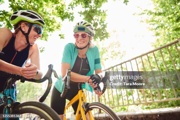 three mature women with racing bicycles - woman on bicycle stock pictures, royalty-free photos & images