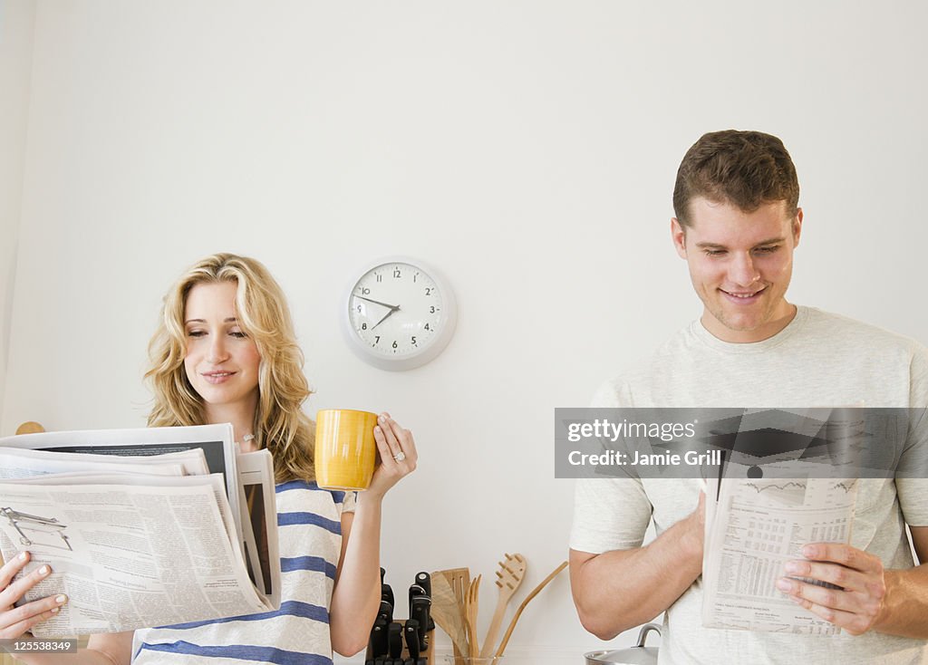 Couple reading newspaper together in the morning
