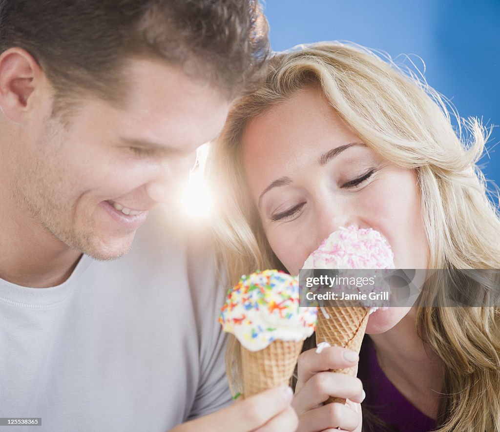 Couple eating ice cream cones together