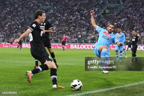 Stephan Lichtsteiner of Juventus is tackled by Alessandro Gamberini of SSC Napoli during the Serie A match between FC Juventus and SSC Napoli at...