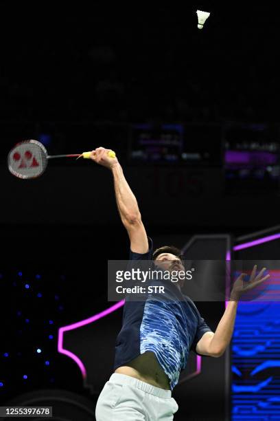 Toma Junior Popov of France hits a return against Cholan Kayan of England during their men's singles match at the Sudirman Cup Finals 2023 world...