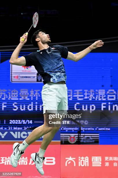 Toma Junior Popov of France hits a return against Cholan Kayan of England during their men's singles match at the Sudirman Cup Finals 2023 world...