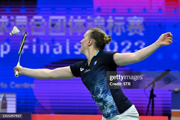Delphine Delrue of France hits a return beside partner Thom Gicquel during their mixed doubles match against Marcus Ellis and Lauren Smith of England...
