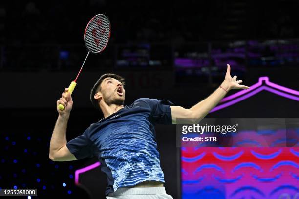 Toma Junior Popov of France hits a return against Cholan Kayan of England during their men's singles match at the Sudirman Cup Finals 2023 world...
