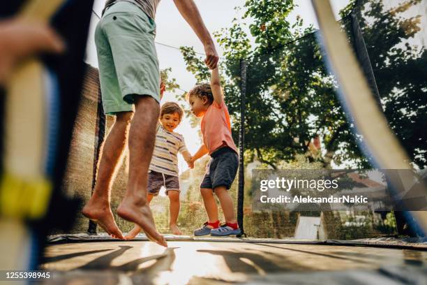 fun on the trampoline - family jumping stock pictures, royalty-free photos & images