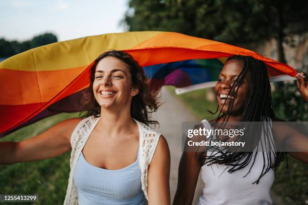 laufen mit stolz - rainbow flag stock-fotos und bilder