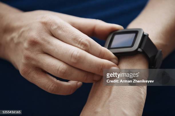 woman with smart watch at gym class. close-up view on hands - results gym stock-fotos und bilder