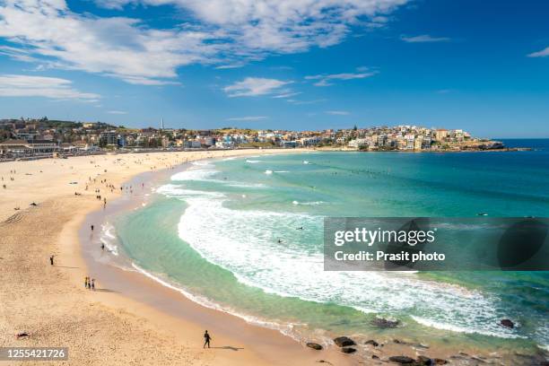 people relaxing on the bondi beach in sydney, australia. bondi beach is one of the most famous beach in the world. - bondi beach stockfoto's en -beelden