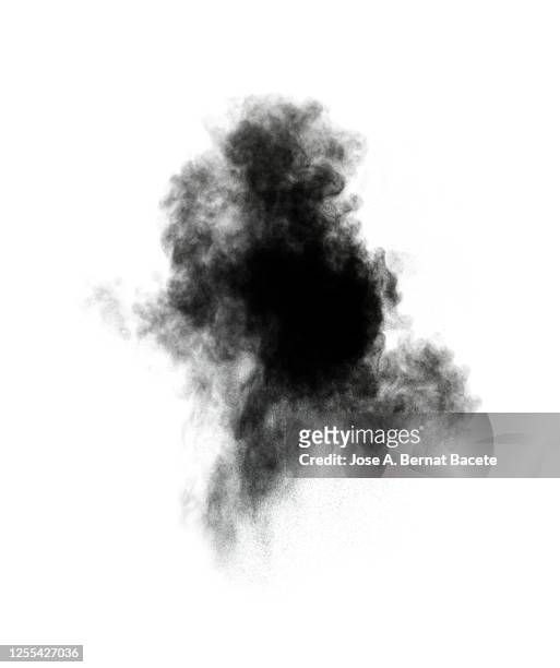 explosion by an impact of a cloud of particles of powder and smoke of black color on a white background. - black smoke stock pictures, royalty-free photos & images