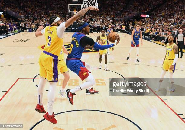 Denver, Colorado May 16, 2023-Nuggets Kentavious Caldwell-Pope attempts a shot in front of Lakers Anthony Davis in the third quarter in Game 1 of the...