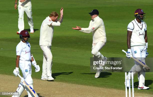 Ben Stokes of England celebrates with Dom Bess after taking the wicket of Jason Holder of the West Indies during Day Three of the 1st #RaiseTheBat...