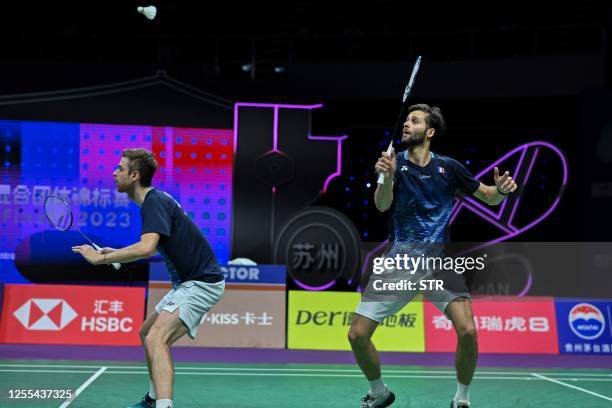 Ronan Labar of France hits a return beside partner Lucas Corvee during their men's doubles match against Ben Lane and Sean Vendy of England at the...