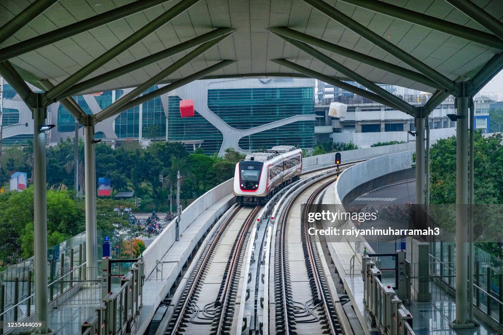 Train approaching Boulevard Utarra Station, Jakarta, Indonesia