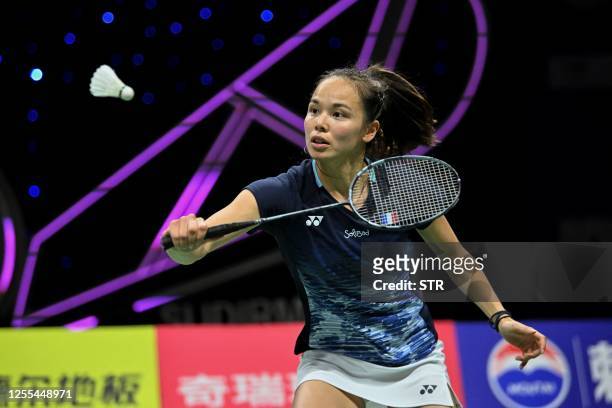 Anne Tran of France hits a return beside partner Margot Lambert during their women's doubles match against Chloe Birch and Lauren Smith of England at...