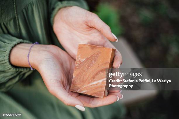 close up hands holding natural bar of soap / shampoo - homemade soap stock pictures, royalty-free photos & images