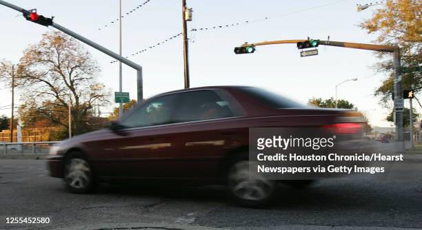 An automobiles runs through a red light at the intersection of Houston Avenue and Memorial Drive in Houston, Texas December 13,2004. James Nielsen