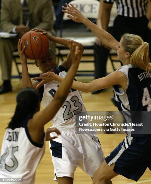 Rice University's Krystal Frazier passes the ball past the University of Nevada's Andrea Sitton to teammate Tiffany Loggins during the first half of...