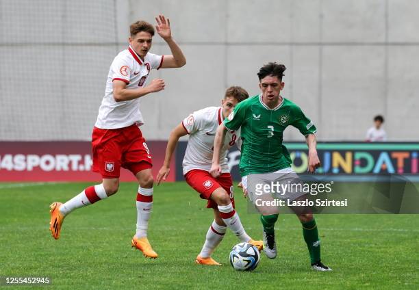 Budapest , Hungary - 17 May 2023; Cory O'Sullivan of Republic of Ireland in action against Oskar Tomczyk of Poland, left, and Karol Borys during the...