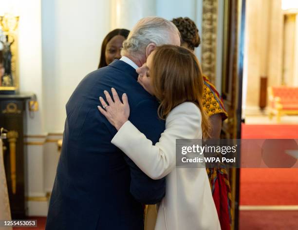 King Charles III meets Geri Horner as he hosts the winners of the Prince's Trust awards and celebrity ambassadors at Buckingham Palace on May 17,...