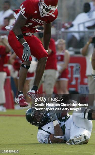 The University of Houston's Will Gulley jumps over Tulane's Chris McGee after McGee recovers a Tulane fumble during the first quarter of Saturday's...