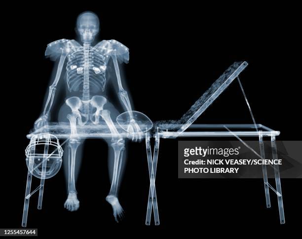 skeleton of american footballer on sports couch, x-ray - funny skeleton stock pictures, royalty-free photos & images