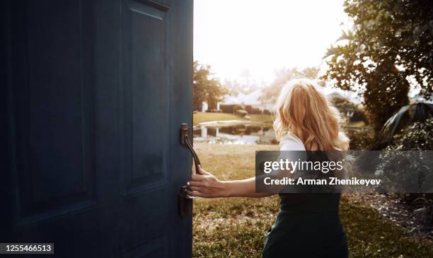 happy woman running next to the open door. nicely fits for book cover - runaway stock pictures, royalty-free photos & images