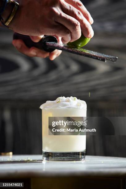 rum, lime, coconut, bitters, whipped cream liquor cocktail - coconut shaving stock pictures, royalty-free photos & images