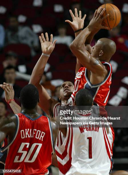 The Houston Rockets Maurice Taylor and Tracy McGrady guard the Charlotte Bobcats Keith Bogans during the second quarter of Wednesday's NBA game at...