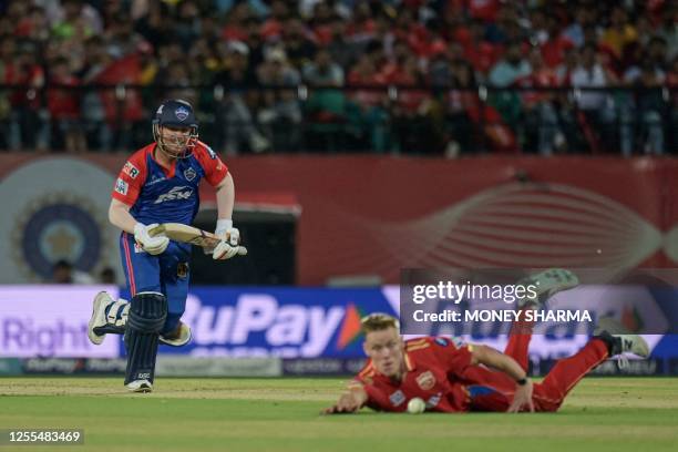 Delhi Capitals' David Warner runs between the wickets during the Indian Premier League Twenty20 cricket match between Punjab Kings and Delhi Capitals...