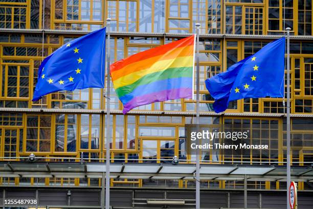 The Rainbow flag and the EU flags are seen in front of the Europa, the EU Council headquarter in Brussels, Belgium, 17 May 2023.