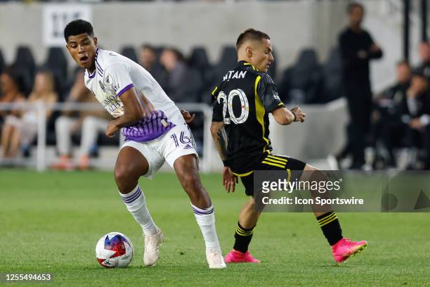 Orlando City midfielder Wilder Cartagena gets the ball from Columbus Crew midfielder Alexandru Matan during the second half in a game on May 13 at...