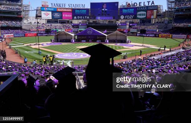 Graduates listen a Finnish Prime Minister Sanna Marin speaks after she received a Doctor of Humane Letters honorary degree during New York...