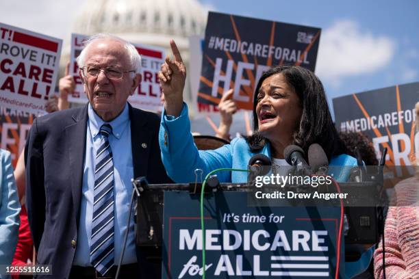 Sen. Bernie Sanders looks on as Rep. Pramila Jayapal during a news conference to announce the re-introduction of the Medicare For All Act of 2023,...