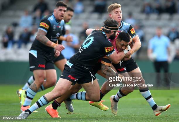 Moses Leota of the Panthers is tackled during the round nine NRL match between the Cronulla Sharks and the Penrith Panthers at Netstrata Jubilee...