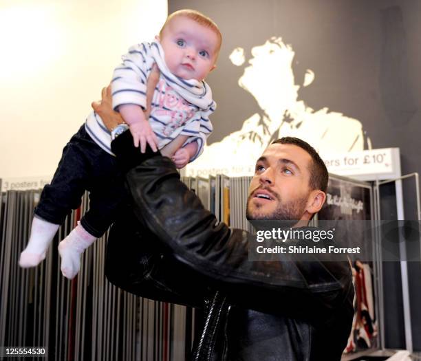 Shayne Ward greets young fan Lexi-Joy Dunleavy while promoting his new album 'Obsession' at HMV on November 15, 2010 in Manchester, England.