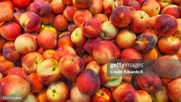 peaches in a fruit shop - nectarine stock pictures, royalty-free photos & images