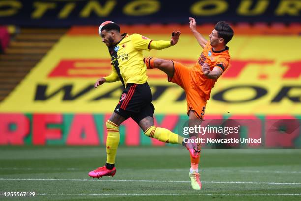 Etienne Capoue of Watford is challenged by Fabian Schar of Newcastle United during the Premier League match between Watford FC and Newcastle United...