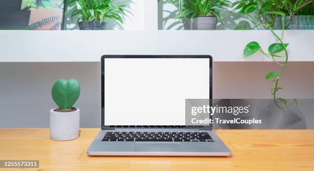 laptop computer blank white screen on table in cafe background. laptop with blank screen on table of coffee shop blur background. - coffee table front view stock pictures, royalty-free photos & images