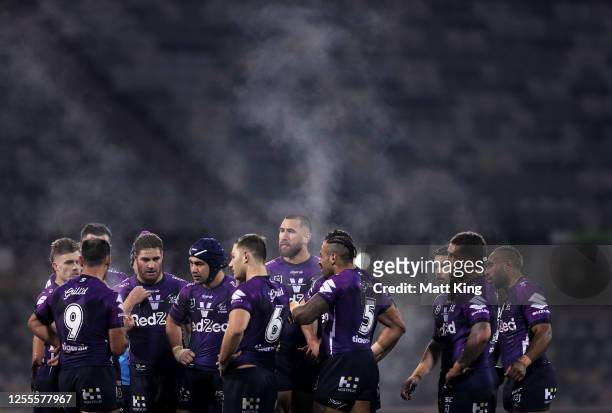 Cameron Smith of the Storm talks to his team mates during the round nine NRL match between the Canberra Raiders and the Melbourne Storm at GIO...