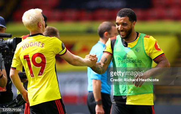 Troy Deeney of Watford celebrates victory with Will Hughes of Watford during the Premier League match between Watford FC and Newcastle United at...