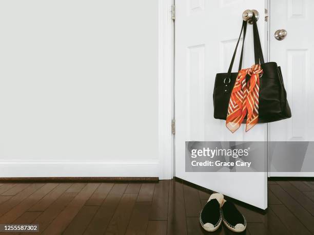 purse hangs on doorknob - orange purse stock pictures, royalty-free photos & images