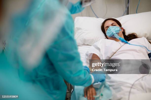 nurse is  checking a covid patient's drip needle at the icu - coronavirus hospital stock pictures, royalty-free photos & images