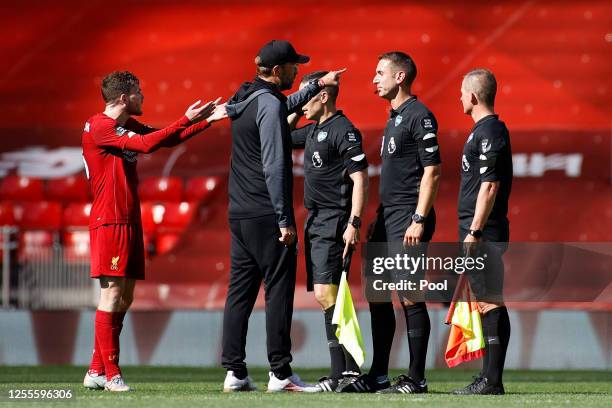 Jurgen Klopp, Manager of Liverpool speaks with Match Referee, David Coote following the Premier League match between Liverpool FC and Burnley FC at...
