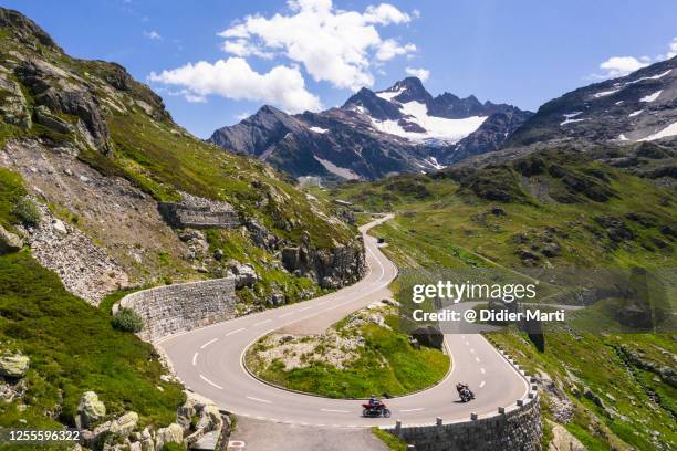 motorcycle ride on the sustenpass mountain road  in the alps in switzerland. - mountain pass stock pictures, royalty-free photos & images