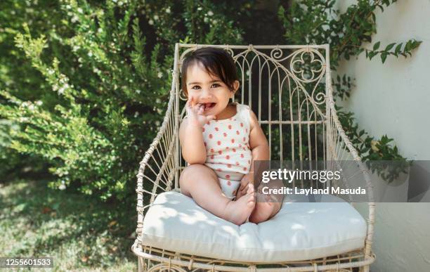 10 month baby girl in outdoor chair - bush baby bildbanksfoton och bilder