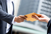 Close up portrait of  businessman hand recieving yellow envelope