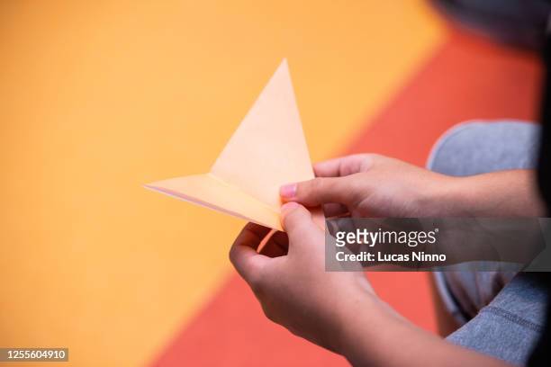 folding paper art - origami spiel stock-fotos und bilder
