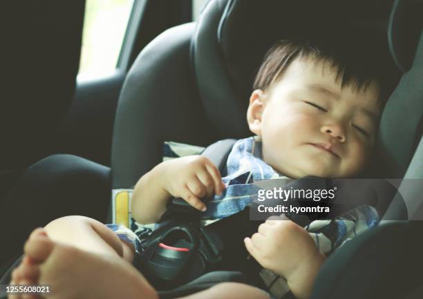 asian baby boy asleep in the car - land vehicle stock pictures, royalty-free photos & images