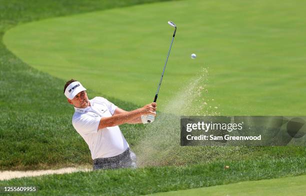 Ian Poulter of England plays a shot from a bunker on the fourth hole during the third round of the Workday Charity Open on July 11, 2020 at Muirfield...